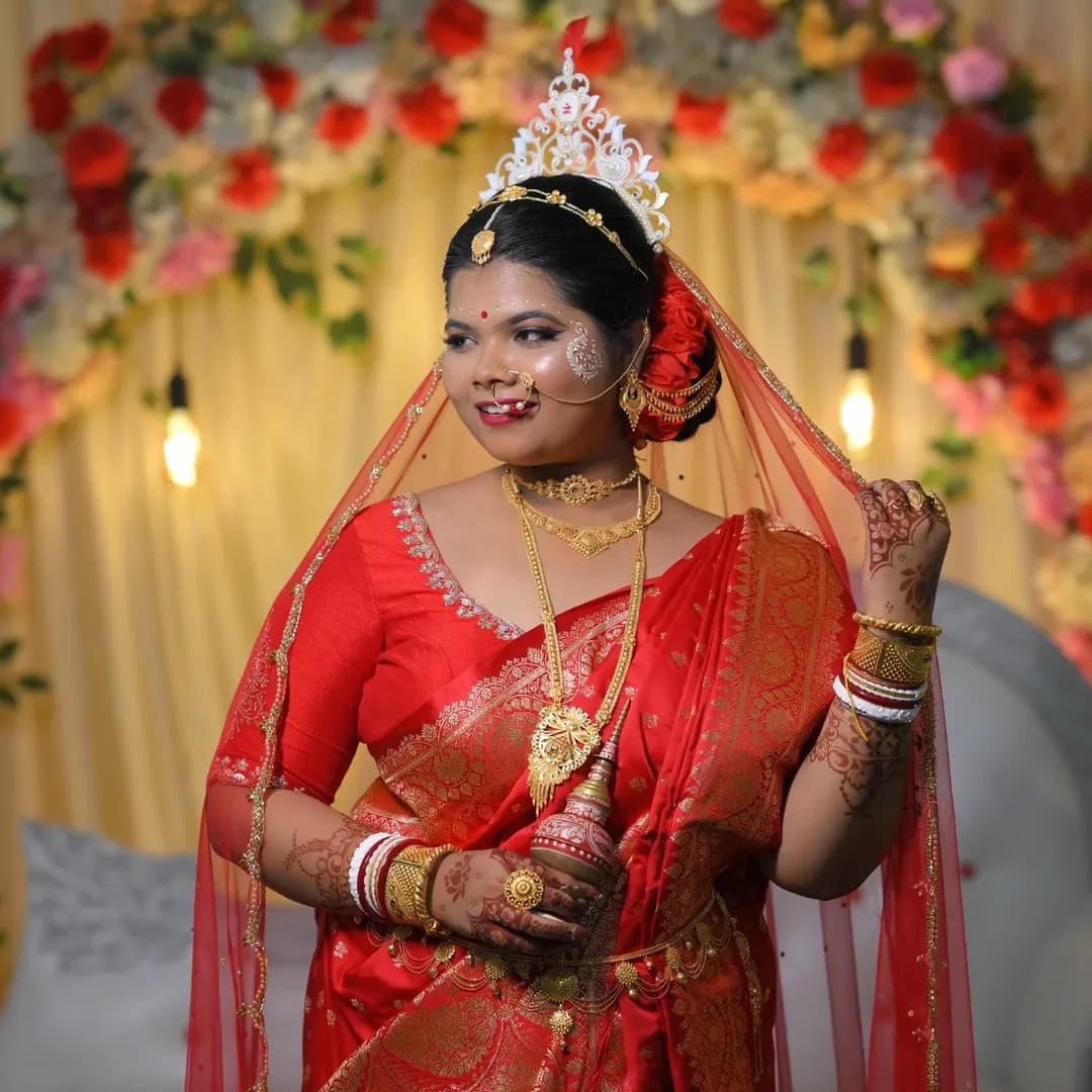 Close-up profile of a Bengali bride showcasing detailed eye makeup and nose ring
